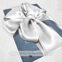 Metal wedding invitation with silver bow closure